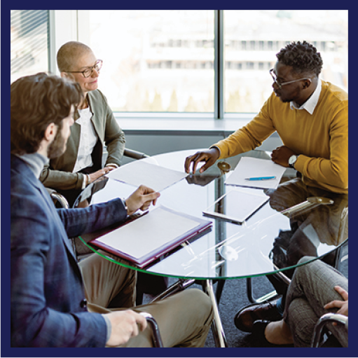 A group of people sitting around a table and talking.
