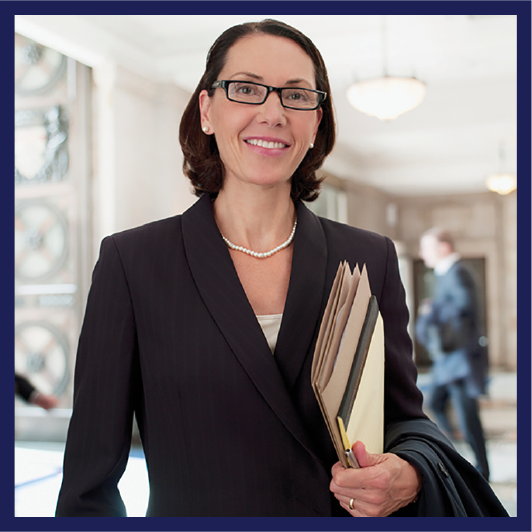 A lawyer wearing a suit and holding a file.