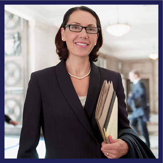 A lawyer wearing a suit and holding a file.