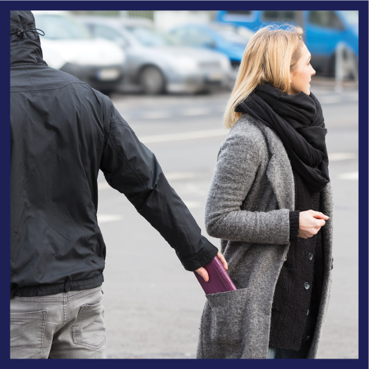 A person stealing something from someone else's pocket.